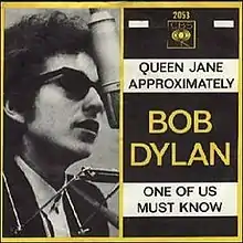 Single cover, including Dylan wearing sunglasses at a microphone