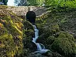a stone bridge over a stream