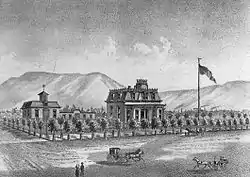 A black-and-white illustration showing the house on a large block surrounded by small trees, with a horse-drawn vehicle in front, large flag on a pole to the right, and mountains in the background