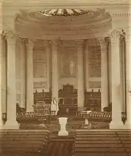 St. Luke's Church interior, view towards chancel.  Rev. Howe standing in chancel in vestments, c.1868
