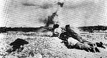 black and white photograph of men firing weapons