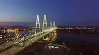 Meeting of the auto club under the Cable-stayed bridge in the evening