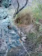 The creek and plutonic rock in Darwin Canyon make the trail tight; the mud can make things slippery.