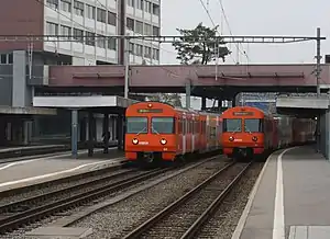 Red trains at side platforms