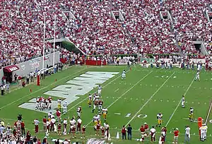 American football players near the end zone near the goal line.