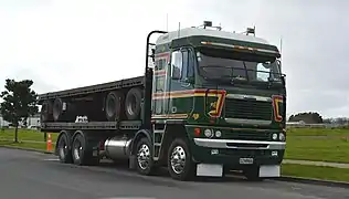 2007 Argosy 8x4 twin-steer in New Zealand transporting flatbed trailer