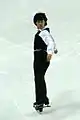 Denis Ten sets up for a jump.