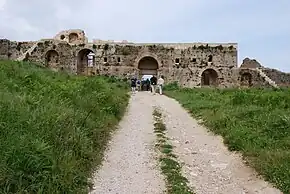 Western gate of Nicopolis, an example of a new polis created by the synoecism of a number of others, which were left abandoned; i.e., Augustus relocated the populations of the surrounding poleis into a new central polis called "Victory City" to commemorate the naval battle of Actium in 31 BC. The reasons were undoubtedly economic, as the new polis brought great prosperity into the area.