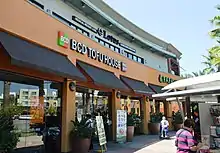 An outdoor mall storefront with the name "BCD Tofu House" above the entrance, and black awnings.