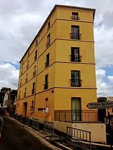 angled apartment block at intersection of two streets