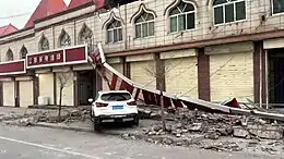 A car crashed onto a border on a building