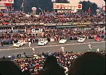 Drivers running to their cars at the start of the race.