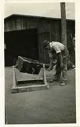 Mixing "Paris green" and road dust preparatory to dusting streams and breeding places of mosquitoes during World War II