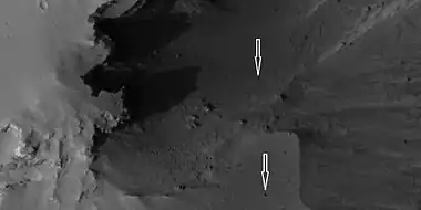 Boulders and their tracks from rolling down a slope, as seen by HiRISE under HiWish program Arrows show two boulders at the end of their tracks.  Location is Arabia quadrangle.