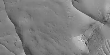 Close view of ridges,  as seen by HiRISE under HiWish program This is an enlargement of a previous image.  A small mesa in the image displays layers.