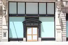 The Coty Building's ground-level storefront, with blue stickers covering all the windows and doors