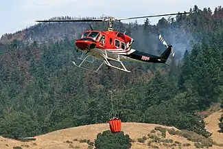 A Bell 212 with a helicopter bucket