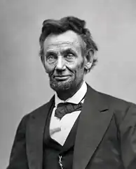 An older, tired-looking Abraham Lincoln with a beard.