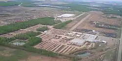 Aerial view of industrial building and airport on north end of community