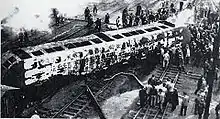 black and white image of a burned rail car on its side