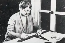 Photo of Alice Washburn drawing plans