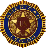 Five-pointed star with the insignia "U.S." enclosed in two bronze bands in the star's center. This design is enclosed in a wreath. Encircling the star and the wreath are the words "American Legion" set in deep blue enamel. This, in turn, is encircled by a narrow band suggestive of the rays of the sun