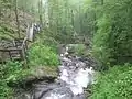 View looking downward showing the stairs of the trail alongside of the waterfall