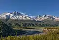 Amulet Peak (left) rising above Matanuska River, with parent Awesome Peak to right of center