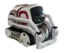 A small, white and gray robot with red highlights and a square black face