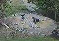 Two students laying the stage bricks