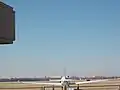 A plane can be seen at Woodring Airport with the Enid skyline in the background.