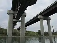 Anthony Henday Drive bridges over the North Saskatchewan River in southwest Edmonton, Alberta. The eastbound bridge includes a pedestrian walkway underneath the bridge.