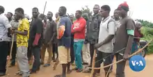 Several young men with a variety of weapons, including bows, spears, slings, and guns