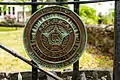 American Legion insignia on gate of cemetery