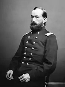 seated man with beard in uniform