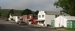 Street with half a dozen one- and two-story buildings