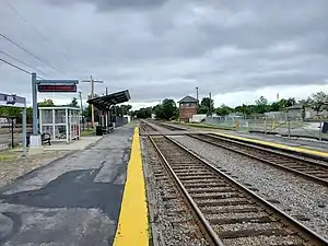 A railway station with two tracks and two low-level side platforms