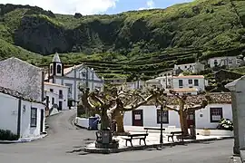 The central square of Fajãzinha, with the Church of Nossa Senhora dos Remédios along the roadway, and the Ladeira do Picado in the background