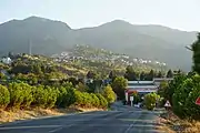 Babadağ from the north (picture taken in 2021 on Babadağ Sarayköy Yolu). On the mountain crest in the background, one sees the towers of the wind park.