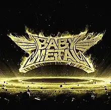 The flaming Babymetal logo, set above a ring of space debris with golden highlights and a background of outer space.