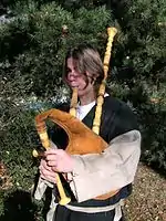 A musician with a Northern Italian Baghèt wearing traditional dress.