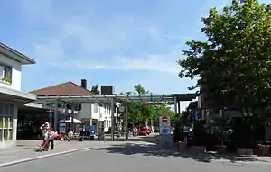 Two-story building with hip roof and canopy-covered wing