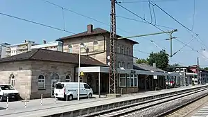 Square two-story stone building with hipped roof