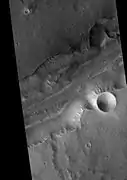 Bahram Vallis in the Lunae Palus quadrangle of Mars, as seen by HiRISE.  Rotational landslides (slumps) are visible at the base of north wall.