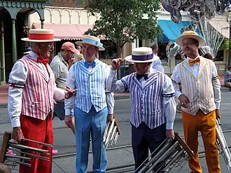 Four members of a barbershop quartet standing around