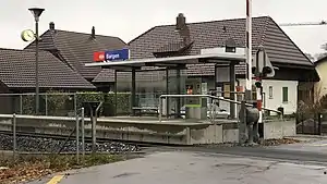 Side platform with shelter next to single-track railway line