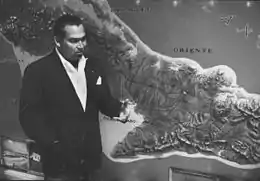 Fulgencio Batista standing in front of a large map of southern Cuba