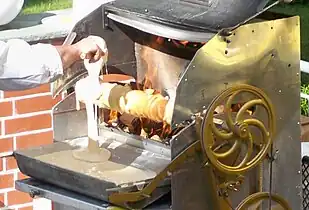 Baumkuchen being prepared on a rotisserie