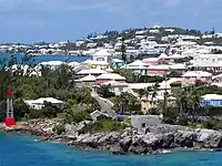 Residential suburb near the old St. George's Garrison, with "Town Cut Battery" or "Gate's Fort" on the shore of the Town Cut, and St. George's Town and its harbour in the background