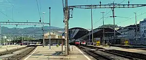 Wide shot of station building in the middle of a half-dozen platforms